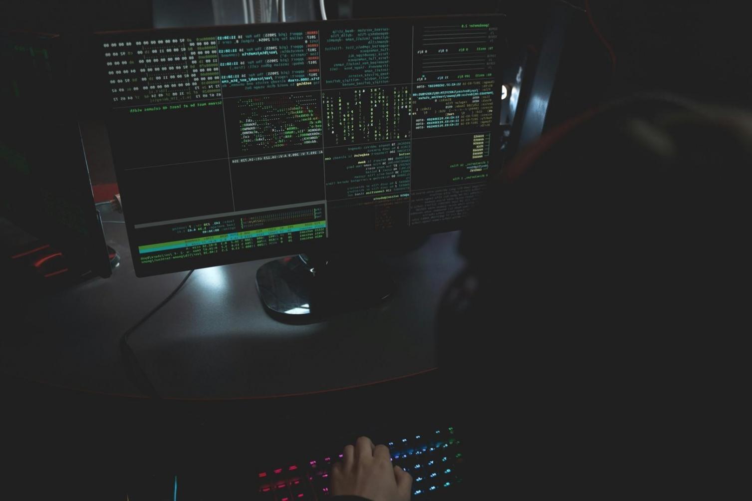 A finance professional studying model outputs on dual monitors in a quiet workspace